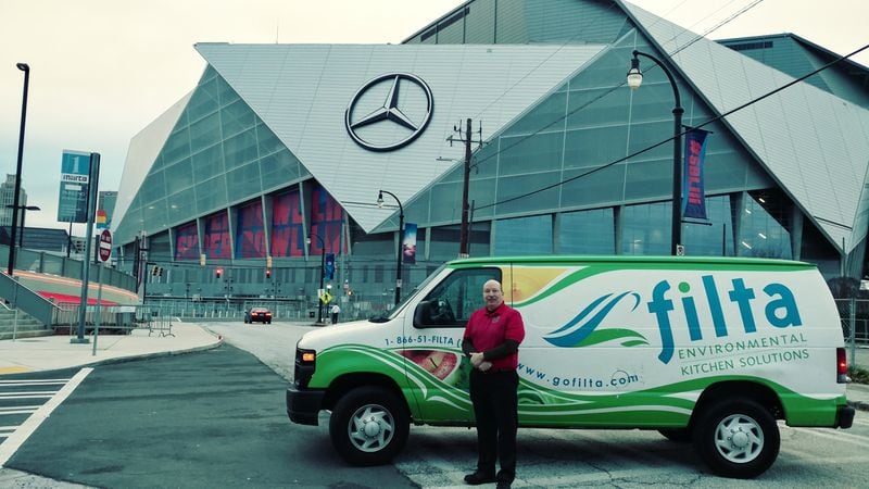 John Lopez, the Atlanta-area Filta franchise owner, posed outside of Mercedes-Benz Stadium next to his company's truck, which was there to filter and recycle the stadium's cooking oil before the Super Bowl.