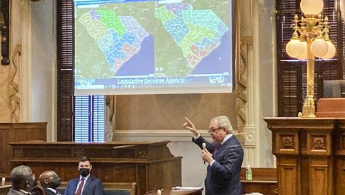 FILE - State Sen. Dick Harpootlian, D-Columbia, compares his proposed map of U.S. House districts drawn with 2020 U.S. Census data to a plan supported by Republicans on Jan. 20, 2022, in Columbia, S.C. A voting rights group sued South Carolina legislative leaders Monday, July 29, 2024, saying the maps they drew based on the 2020 Census lean too far toward Republicans. (AP Photo/Jeffrey Collins, File)