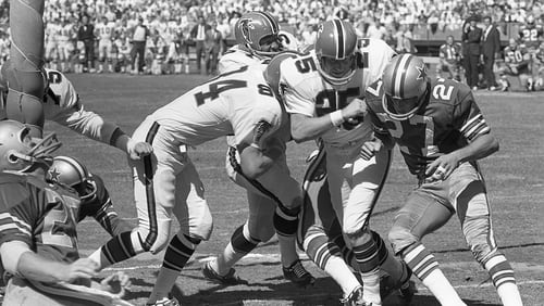 Falcons running back Junior Coffey reaches the end zone thanks to blocks by Verne Burke (84) and Alex Hawkins (25). AJC file photo