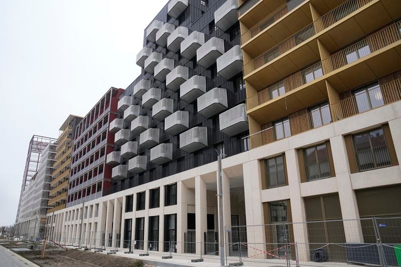 FILE - Buildings of the Olympic Village are pictured, Friday, Dec. 1, 2023 in Saint-Denis, outside Paris. The Paris 2024 Olympic Games will run from July 26 to Aug.11, 2024. The U.S. Olympic team is one of a handful that will supply air conditioners for their athletes at the Paris Games in a move that undercuts organizers' plans to cut carbon emissions. (AP Photo/Michel Euler, File)