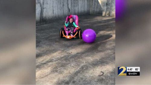 Kessley Hales, 6, plays in a new ATV built specifically for her by Etowah High School's robotics team.