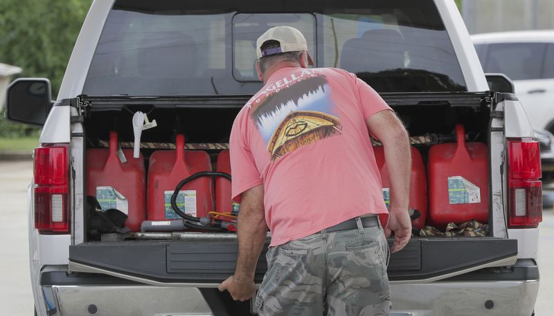 Steve Pete filled up gas containers to give to neighbors and the elderly if they need it ahead of Tropical Storm Francine in Violet, La. Monday, Sept. 9, 2024. (David Grunfeld/The Times-Picayune/The New Orleans Advocate via AP)