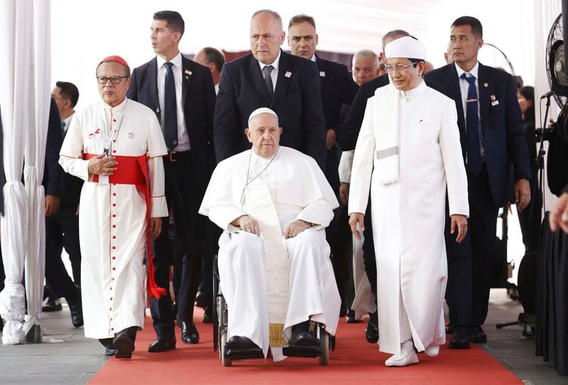 Pope Francis, center, accompanied by the grand imam of Istiqlal Mosque Nasaruddin Umar, right, and Archbishop of Jakarta Cardinal Ignatius Suharyo, visits the tunnel of friendship that connects Istiqlal Mosque and the Jakarta Cathedral as he arrives at the Istiqlal Mosque for an interreligious meeting in Jakarta Thursday, Sept. 5, 2024. (Mast Irham/Pool Photo via AP)