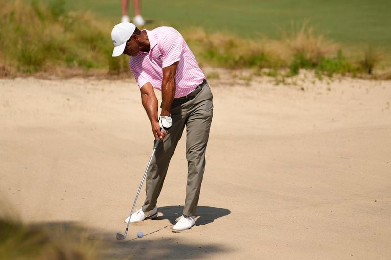 Tiger Woods hits from the bunker on the fourth hole during the first round of the U.S. Open golf tournament Thursday, June 13, 2024, in Pinehurst, N.C. (AP Photo/George Walker IV)
