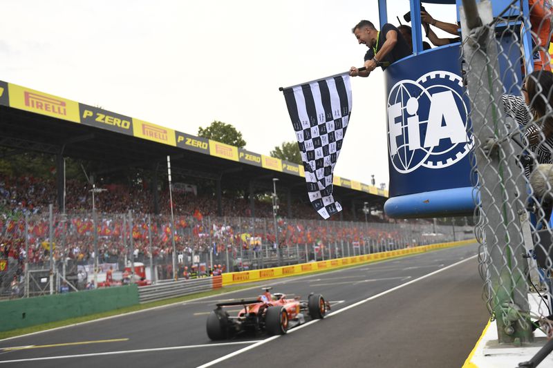 Ferrari driver Charles Leclerc of Monaco crosses the finish line to win the Formula One Italian Grand Prix race at the Monza racetrack, in Monza, Italy, Sunday, Sept. 1, 2024. ({byline}/Pool Photo via AP)