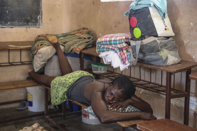 A person displaced by armed gang attacks rests at the Antoinette Dessalines National School, a makeshift shelter, in Saint-Marc, Haiti, Sunday, Oct. 6, 2024. (AP Photo/Odelyn Joseph)