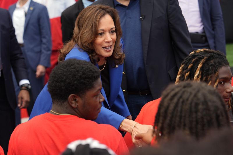 Democratic presidential nominee Vice President Kamala Harris greets members of the Aliquippa High School football team during a campaign stop at their school, Sunday, Aug. 18, 2024, in Aliquippa, Pa. (AP Photo/Julia Nikhinson)