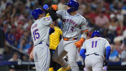 New York Mets' Francisco Alvarez (4) celebrates his three run home run off Philadelphia Phillies' Aaron Nola with Mets' Tyrone Taylor (15) during the fifth inning of a baseball game, Friday, Sept. 13, 2024, in Philadelphia. (AP Photo/Derik Hamilton)