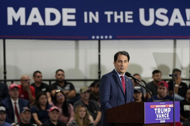 Former Wisconsin Gov. Scott Walker arrives before Republican presidential nominee former President Donald Trump at a campaign event at Dane Manufacturing, Tuesday, Oct. 1, 2024, in Waunakee, Wis. (AP Photo/Charlie Neibergall)