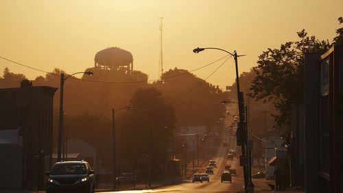 The sun rises over the city of Springfield, Ohio, Monday, Sept. 16, 2024. (AP Photo/Jessie Wardarski)