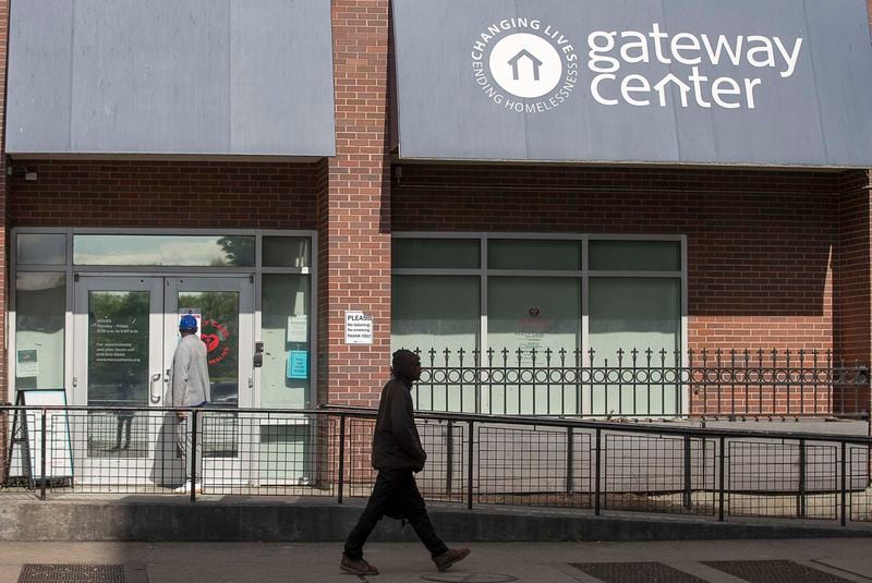 A man waits to be let into the Mercy Care Clinic at the Gateway Center in Atlanta in April. The Gateway Center is a homeless service center. (ALYSSA POINTER / ALYSSA.POINTER@AJC.COM)