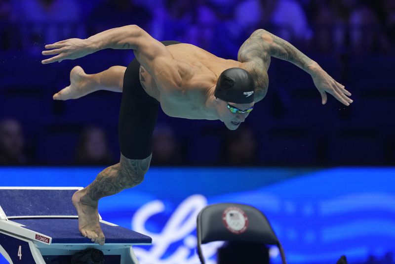 Caeleb Dressel swims during the men's 100 butterfly semifinals heat Friday, June 21, 2024, at the US Swimming Olympic Trials in Indianapolis. (AP Photo/Michael Conroy)