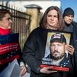 FILE - Belarusian opposition leader Sviatlana Tsikhanouskaya, center, holds a portrait of her jailed husband, Siarhei Tsikhanouski, at a protest outside the Belarus Embassy, in Vilnius, Lithuania, on March 8, 2024, demanding freedom for political prisoners. (AP Photo/Mindaugas Kulbis, File)