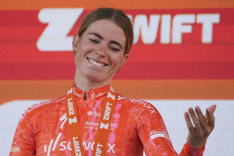 Stage winner Demi Vollering of The Netherlands reacts on the podium after the eighth stage of the Tour de France Women cycling race with start in Le Grand-Bornand and finish in Alpe d'Huez, France, Sunday, Aug. 18, 2024. (AP Photo/Peter Dejong)