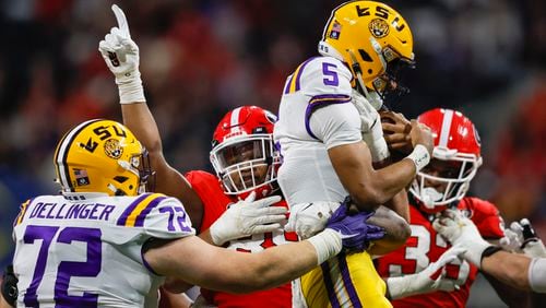 Georgia Bulldogs defensive lineman Jalen Carter (88) tackles LSU Tigers quarterback Jayden Daniels (5) during the second quarter of the SEC Championship Game at Mercedes-Benz Stadium in Atlanta on Saturday, Dec. 3, 2022. (Jason Getz / Jason.Getz@ajc.com)