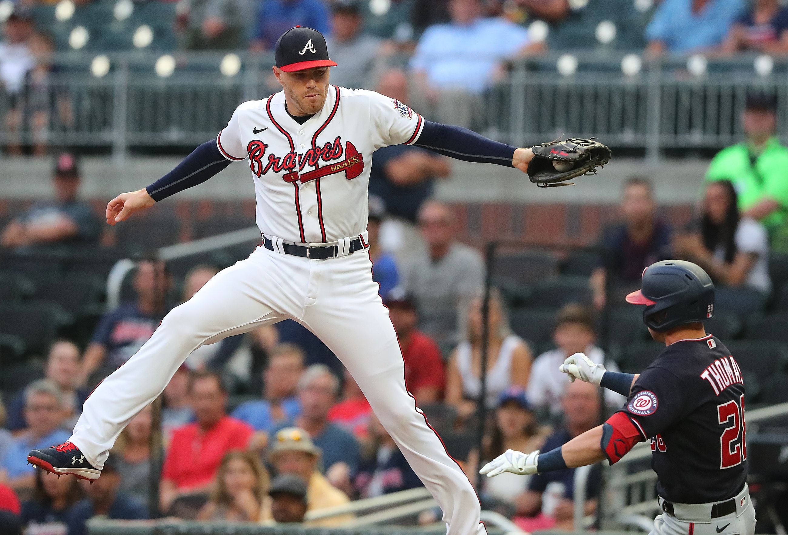 May 08, 2021: Atlanta Braves first baseman Freddie Freeman adjusts his hat  as he runs onto the field before the start of the ninth inning of a MLB  game against the Philadelphia