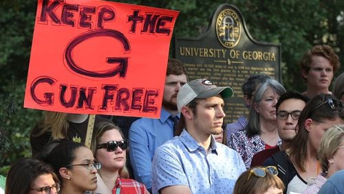 Students, faculty, staff and local residents hold a protest last week at the University of Georgia to oppose a bill to allow the concealed carrying of guns on the state’s public college and university campuses. Curtis Compton/ccompton@ajc.com