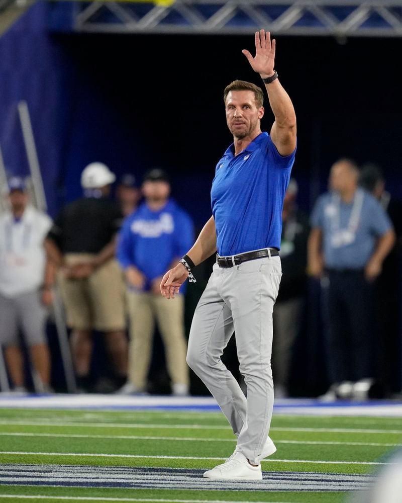 Former Kentucky quarterback Tim Coucz waves to fans after being introduced during the first half of an NCAA college football game between Kentucky and Georgia, Saturday, Sept. 14, 2024, in Lexington, Ky. (AP Photo/Darron Cummings)