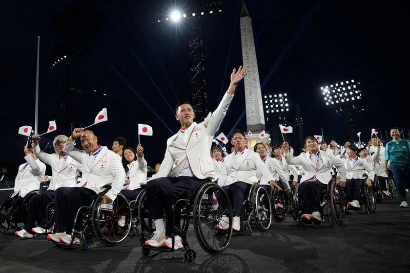 Members of the Japanese delegation parade during the Opening Ceremony for the 2024 Paralympics, Wednesday, Aug. 28, 2024, on Concorde plaza in Paris, France. (AP Photo/Christophe Ena)