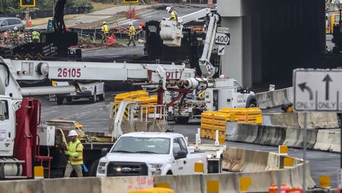 April 14, 2023 Sandy Springs: Looking westbound on Abernathy Road, construction crews were hard at it on Friday, April 14, 2023  when the state opens a diverging-diamond interchange at Abernathy Road under the Ga. 400 overpass. Under the diverging-diamond layout, motorists on Abernathy will move to the opposite side of the road to more easily access Ga. 400 ramps or to continue along Abernathy. Eastbound traffic will shift from the right side of Abernathy to the left side to turn onto the northbound Ga. 400 ramp or to continue east on Abernathy. Westbound traffic will also move from the right to the left side of the road to turn south on Ga. 400 or to continue west on Abernathy. Weather permitting, the interchange will open Monday. The Georgia Department of Transportation must still finish striping and other work. Beginning at 9 p.m. Thursday, the agency will close Abernathy Road under Ga. 400. Traffic exiting Ga. 400 onto Abernathy Road will only be able to turn right. GDOT will implement a series of detours to direct traffic through the area. GDOT has constructed diverging-diamond interchanges across metro Atlanta, including on I-85 at Pleasant Hill Road and Jimmy Carter Boulevard, on I-285 at Ashford Dunwoody Road and Camp Creek Parkway and on I-75 at Windy Hill Road. The new Abernathy Road interchange is a key part of the massive construction project surrounding the I-285 interchange at Ga. 400. The project began in 2017 and — after a series of delays — is expected to be completed later this year. (John Spink / John.Spink@ajc.com)

