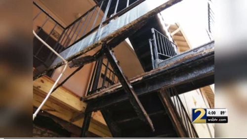 An Atlanta woman holding her daughter was injured Thursday when a walkway leading to a stairwell outside her apartment collapsed, authorities said.