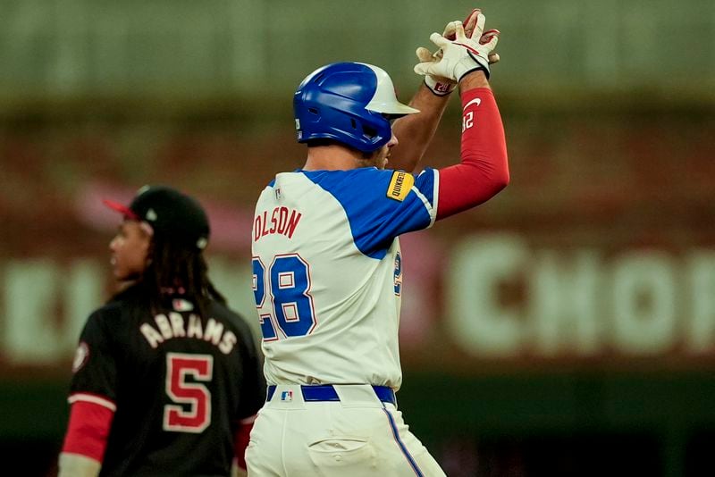 Atlanta Braves' Matt Olson (28) celebrates his RBI-double against the Washington Nationals nin the sixth inning of a baseball game, Saturday, Aug. 24, 2024, in Atlanta. (AP Photo/Mike Stewart)