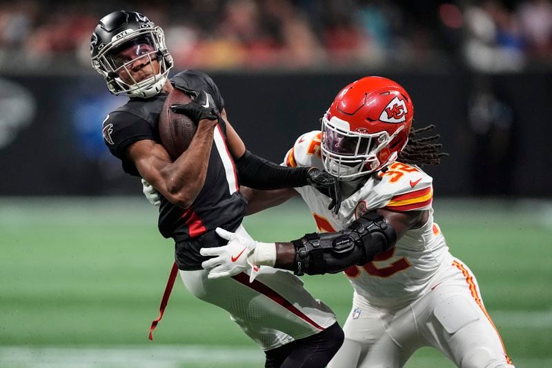 Kansas City Chiefs linebacker Nick Bolton (32) hits Atlanta Falcons wide receiver Darnell Mooney (1) during the first half of an NFL football game, Sunday, Sept. 22, 2024, in Atlanta. (AP Photo/Brynn Anderson)