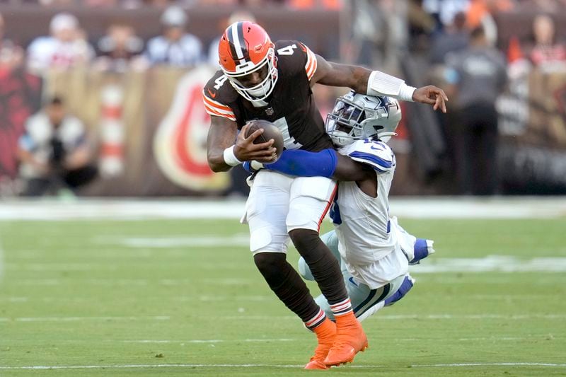 Cleveland Browns quarterback Deshaun Watson (4) is tackled by Dallas Cowboys linebacker DeMarvion Overshown, right, in the second half of an NFL football game in Cleveland, Sunday, Sept. 8, 2024. (AP Photo/Sue Ogrocki)