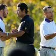 International team member Hideki Matsuyama of Japan shakes hands with United States team members Russell Henley, left, and Xander Schauffele, right, after winning their second round foursome match 7&6 at the Presidents Cup golf tournament at Royal Montreal Golf Club Friday, September 27, 2024 in Montreal. (Frank Gunn/The Canadian Press via AP)