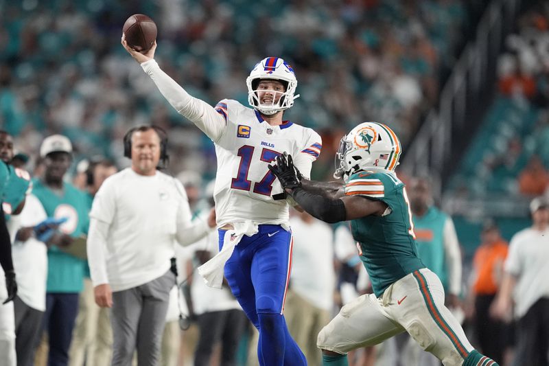 Buffalo Bills quarterback Josh Allen (17) aims a pass under pressure from Miami Dolphins linebacker David Long Jr. during the second half of an NFL football game, Thursday, Sept. 12, 2024, in Miami Gardens, Fla. (AP Photo/Rebecca Blackwell)