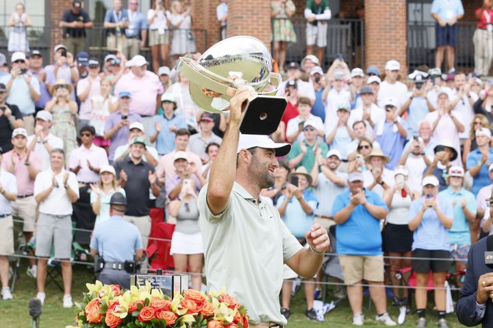 Scottie Scheffle celebrates with the FedEx Cup trophy after winning the Tour Championship at East Lake Golf Club Sunday, Sept. 1, 2023, in Atlanta. 
(Miguel Martinez / AJC)