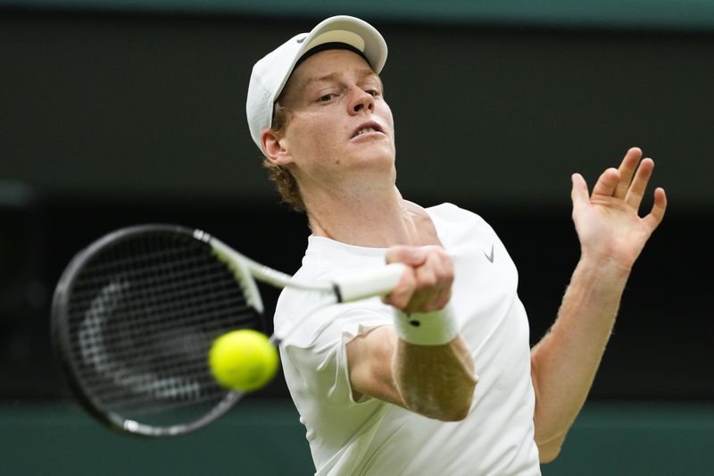 Jannik Sinner of Italy plays a forehand return to Daniil Medvedev of Russia during their quarterfinal match at the Wimbledon tennis championships in London, Tuesday, July 9, 2024. (AP Photo/Alberto Pezzali)