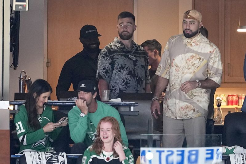 Kansas City Chiefs' Travis Kelce, center, and others take in Game 2 of the Western Conference finals in the NHL hockey Stanley Cup playoffs between the Edmonton Oilers and the Dallas Stars, Saturday, May 25, 2024, in Dallas. (AP Photo/Tony Gutierrez)
