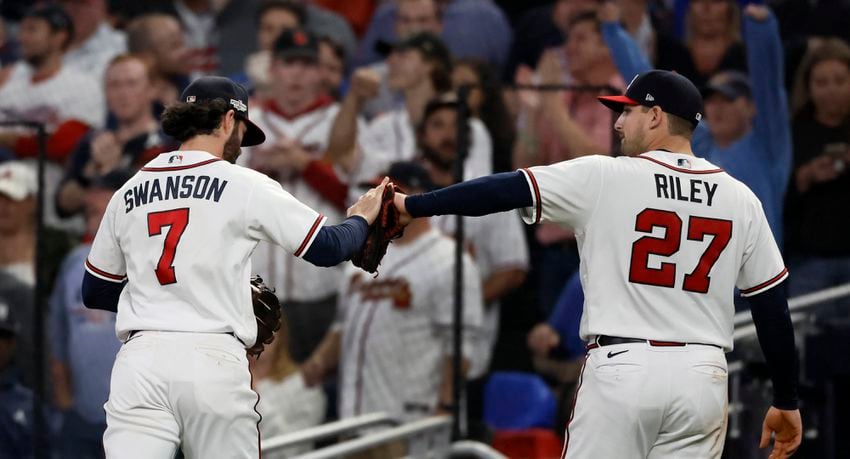 Atlanta Braves shortstop Dansby Swanson (7) celebrates with third baseman Austin Riley (27) after an over the shoulder catch of the popup by Philadelphia Phillies’ J.T. Realmuto during the sixth inning of game two of the National League Division Series at Truist Park in Atlanta on Wednesday, October 12, 2022. (Jason Getz / Jason.Getz@ajc.com)