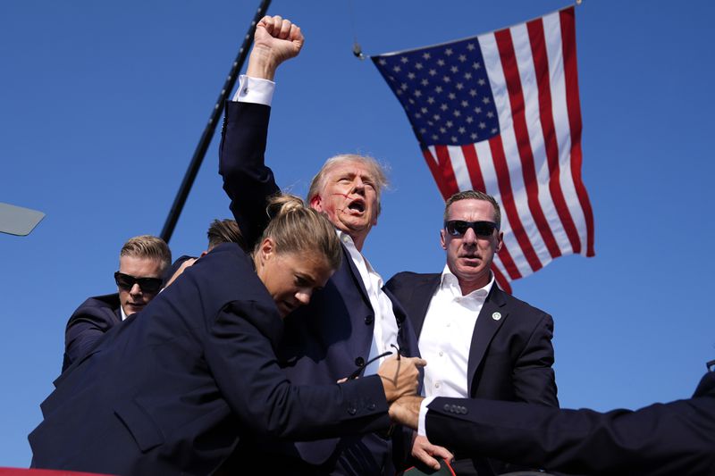 FILE - Republican presidential candidate former President Donald Trump is surrounded by U.S. Secret Service agents at a campaign rally, July 13, 2024, in Butler, Pa. (AP Photo/Evan Vucci, File)