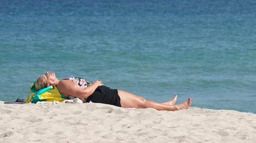 A beachgoer takes a nap on Fort Lauderdale beach, Thursday, Dec. 22, 2022, in Fort Lauderdale, Fla.  (AP Photo/Marta Lavandier, File)