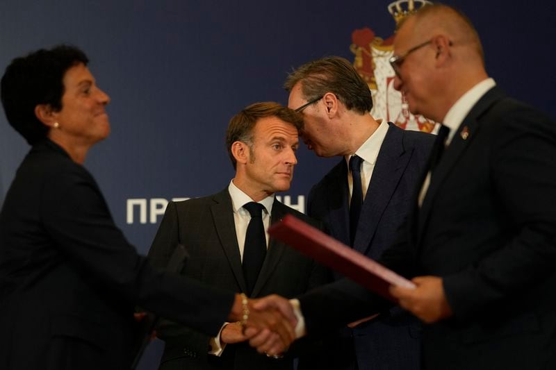 French President Emmanuel Macron, left, and Serbian President Aleksandar Vucic speak after the signing of bilateral documents in Belgrade, Serbia, Thursday, Aug. 29, 2024. French President Emmanuel Macron starts a two-day state visit to Serbia with the focus on a possible sale of 12 Rafale multi-purpose fighter jets to a country that has maintained close ties to Russia despite its aggression on Ukraine. (AP Photo/Darko Vojinovic)