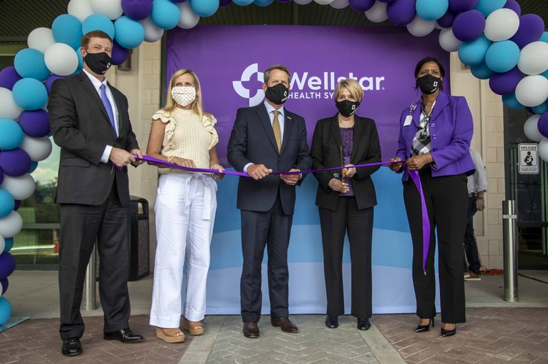 07/16/2020 - Marietta, Georgia - Otis Brumbly, III, from left), Wellstar Health System Board of Trustee Chair, Georgia First Lady Marty Kemp, Gov. Brian Kemp (center), Candice Saunders, president and CEO of Wellstar Health System and Mary Chatman (right), executive vice president of Wellstar Health System and president of Wellstar Kennestone and Wellstar Windy Hill Hospitals, participate in a ribbon cutting ceremony for the new Wellstar Kennestone Hospital Emergency Department building in Marietta, Thursday, July 16, 2020. The department is a 263,000-square-foot facility, which will be one of the top two largest and busiest emergency departments in the nation (ALYSSA POINTER / ALYSSA.POINTER@AJC.COM)