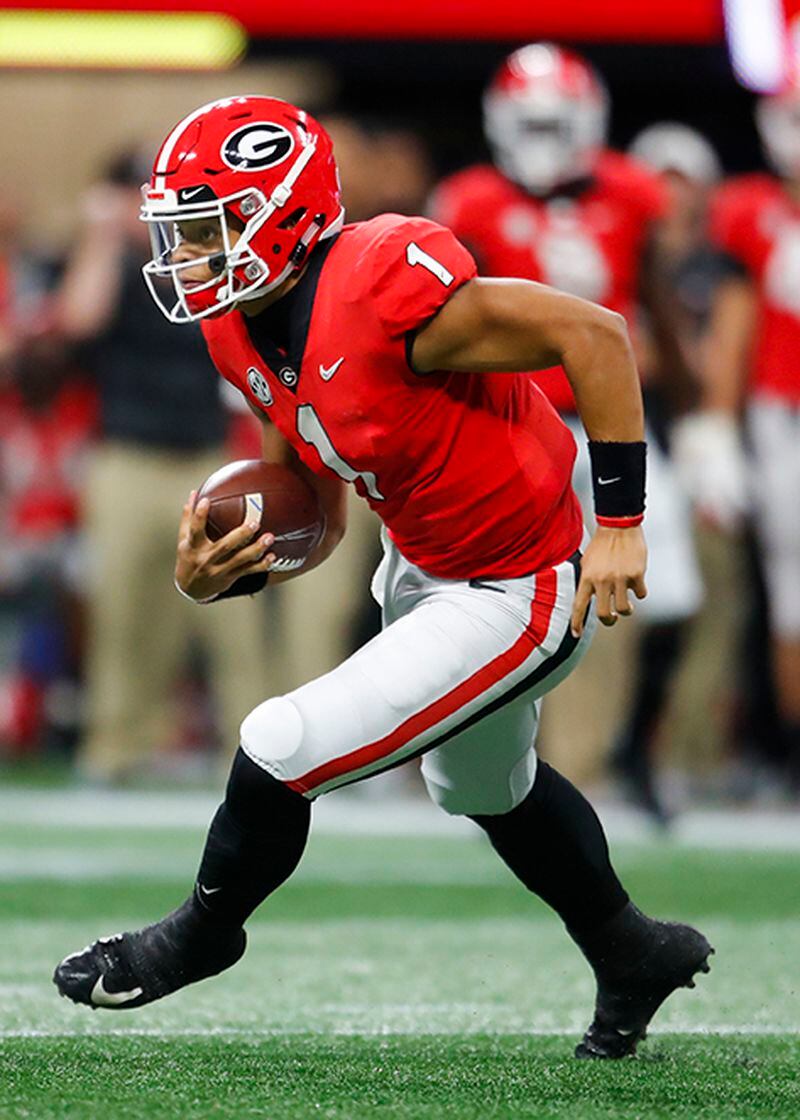 Bulldogs quarterback Justin Fields scrambles during the SEC Championship game.