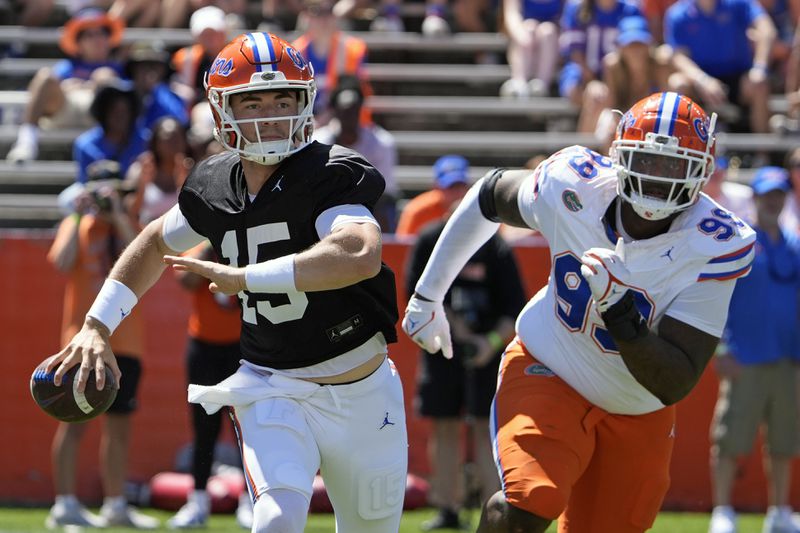 FILE - Florida quarterback Graham Mertz, left, looks for a receiver as defensive lineman Cam Jackson puts on pressure during the NCAA college football team's spring game, Saturday, April 13, 2024, in Gainesville, Fla. (AP Photo/John Raoux, File)