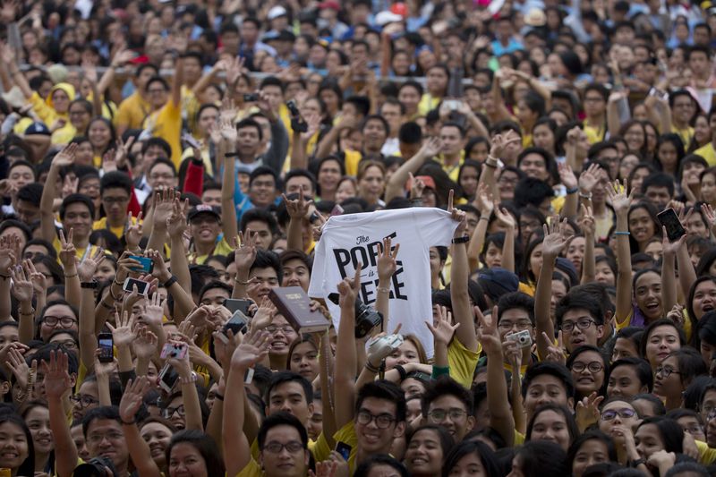 FILE - Young people wait for the arrival of Pope Francis in Santo Tomas University in Manila, Philippines, on Jan. 18, 2015. (AP Photo/Alessadra Tarantino, File)