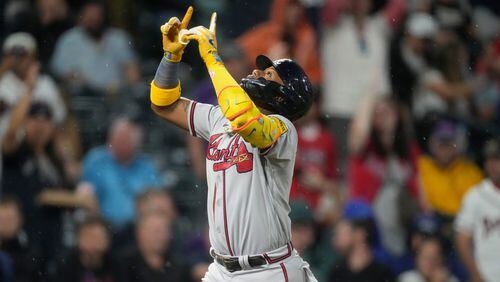 Atlanta Braves' Ronald Acuna Jr. gestures as he crosses home plate after hitting a two-run home run off Colorado Rockies relief pitcher Karl Kauffmann in the fifth inning of a baseball game Monday, Aug. 28, 2023, in Denver (AP Photo/David Zalubowski)