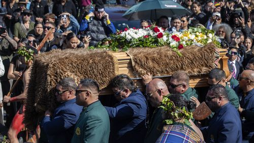 The coffin with the body of New Zealand's Maori King, Kiingi Tuheitia Pootatau Te Wherowhero VII, is carried up Taupiri Mountain for burial in Ngaruawahia, New Zealand, Thursday, Sept. 5, 2024. (AP Photo/Alan Gibson)