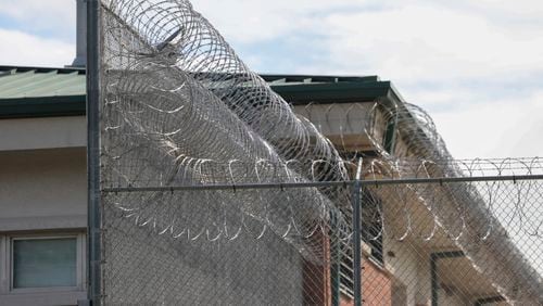 Barbed wire wraps around the fence at the Gainesville Regional Youth Detention Center in Gainesville. Colt Gray, 14, is currently being held at the center after allegedly killing four people at Apalachee High School in Barrow County. (Jason Getz / AJC)