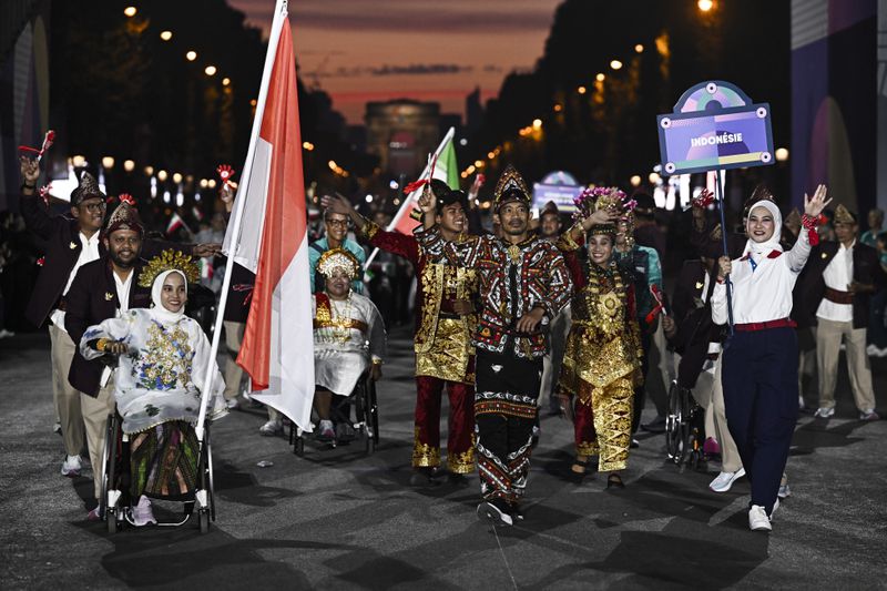 Indonesia's delegation arrives during the Parade of Nations as part of the Paris 2024 Paralympic Games Opening Ceremony at the Place de la Concorde in Paris, France, Wednesday Aug. 28, 2024. (Julien De Rosa/Pool Photo via AP)