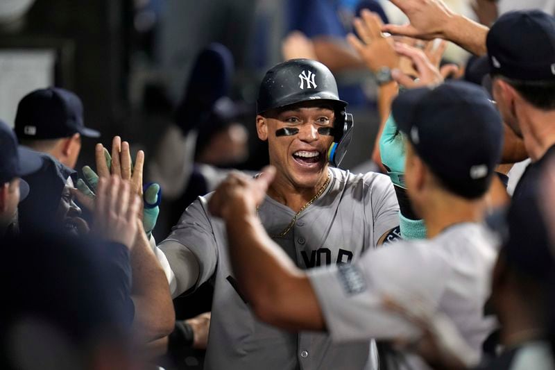 New York Yankees designated hitter Aaron Judge celebrates after hitting his 300th career home run, the fastest player to do so in MLB history, during the eighth inning of a baseball game against the Chicago White Sox, Wednesday, Aug. 14, 2024, in Chicago. (AP Photo/Erin Hooley)