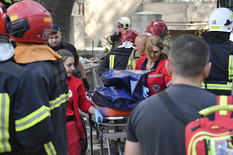 Rescuers carry a body after Russian missile attack in centre Lviv, Western Ukraine, Wednesday Sept. 4, 2024. (AP Photo/Mykola Tys)