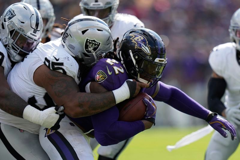 Las Vegas Raiders defensive tackle John Jenkins (95) tackles Baltimore Ravens running back Derrick Henry (22) during the second half of an NFL football game, Sunday, Sept. 15, 2024, in Baltimore. (AP Photo/Stephanie Scarbrough)