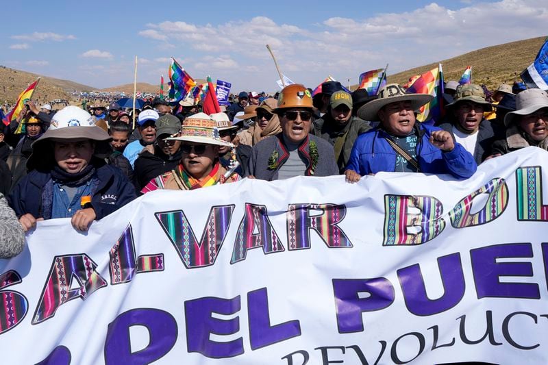 Former President Evo Morales, center, and his supporters march to the capital to protest against the government of current President Luis Arce, in an escalation of a political dispute between the two politicians, in Vila Vila, Bolivia, Tuesday, Sept. 17, 2024. (AP Photo/Juan Karita)