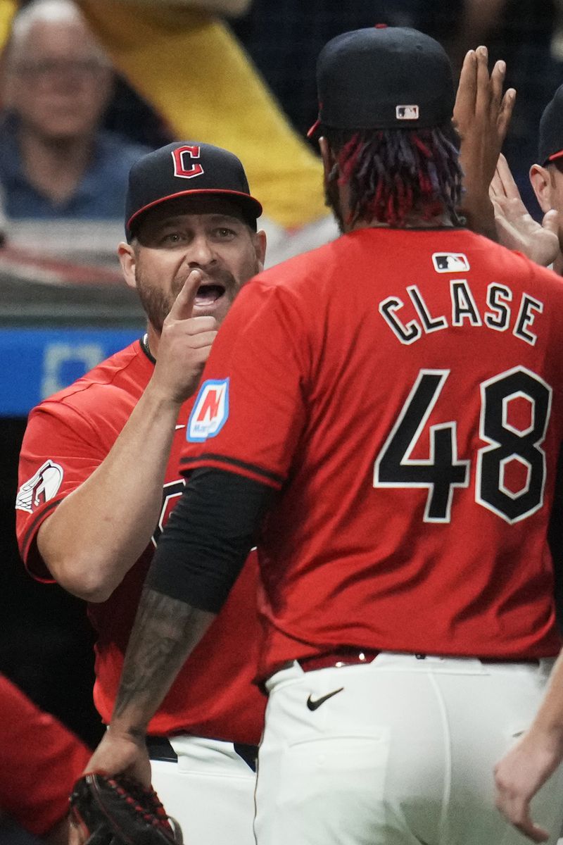 Cleveland Guardians manager Stephen Vogt, left, greets relief pitcher Emmanuel Clase (48) after they defeated the Minnesota Twins in a baseball game Monday, Sept. 16, 2024, in Cleveland. (AP Photo/Sue Ogrocki)